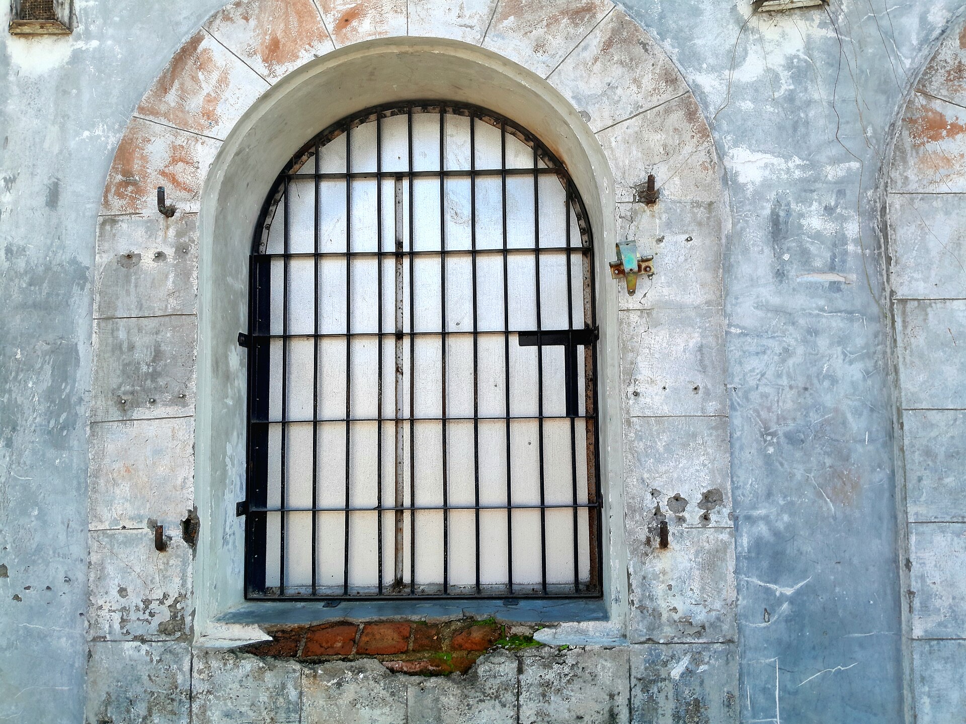 An old prison window with iron bars